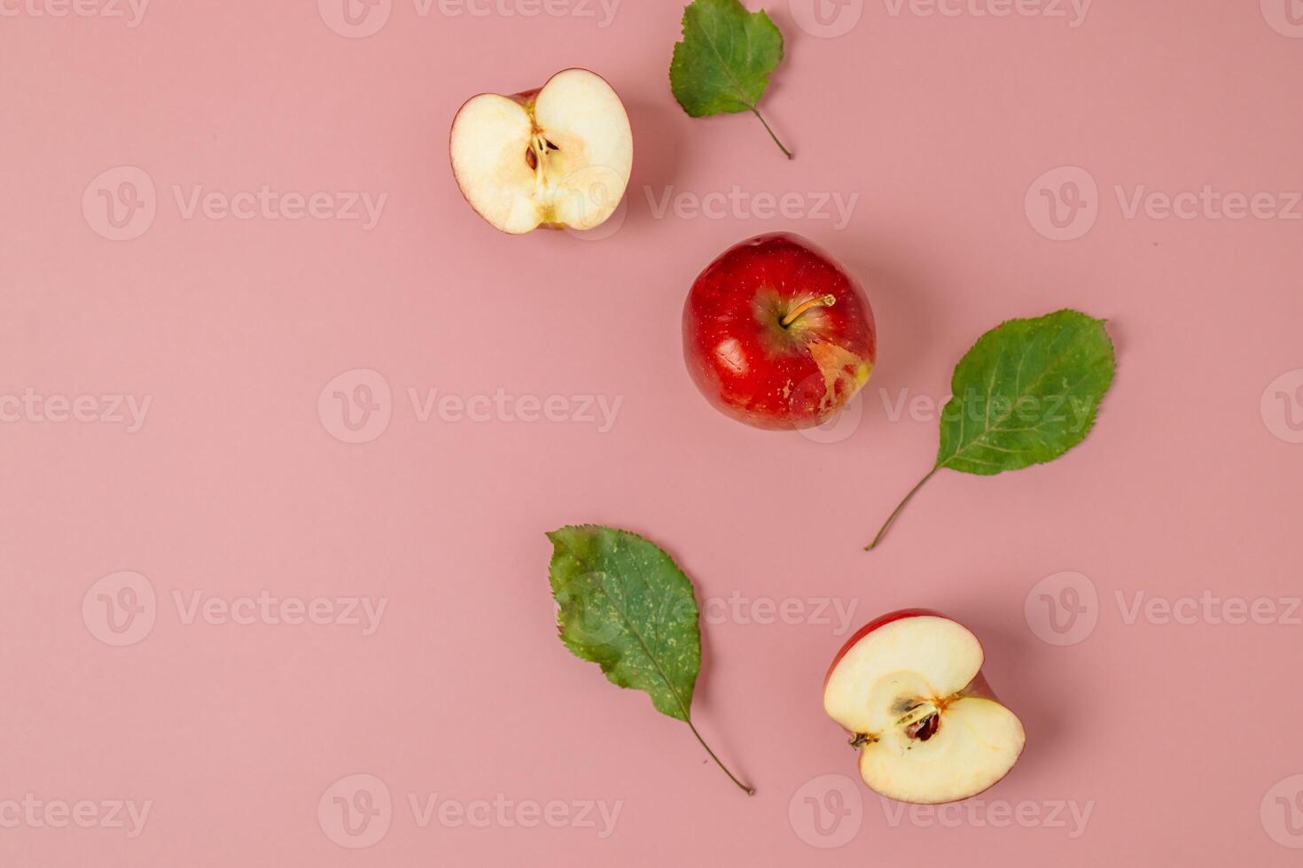 Red apple, half apple and quarter apple on pink background. Top view, healthy food concept. Top view. photo