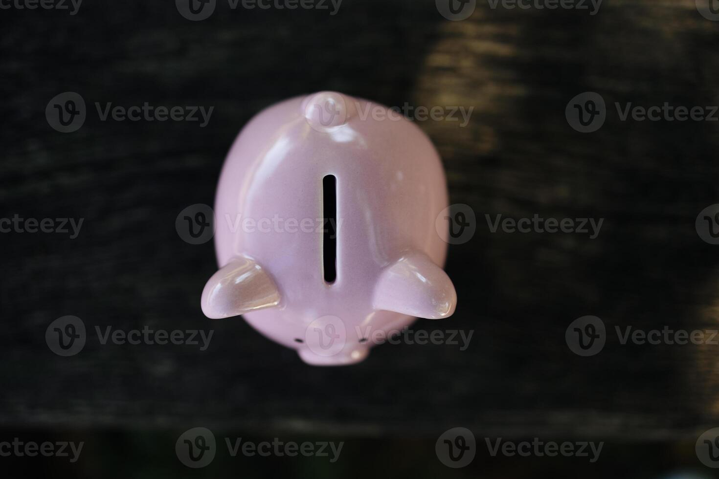 Pink piggy bank with a blessed one. concept of failure in saving and bad finances photo
