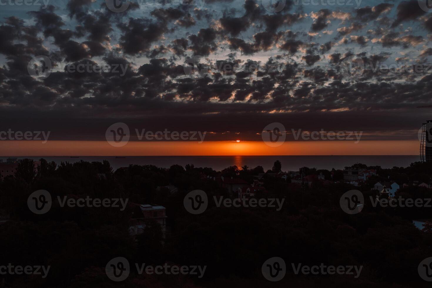 Evening sky with dramatic clouds over the sea. Dramatic sunset over the sea. photo