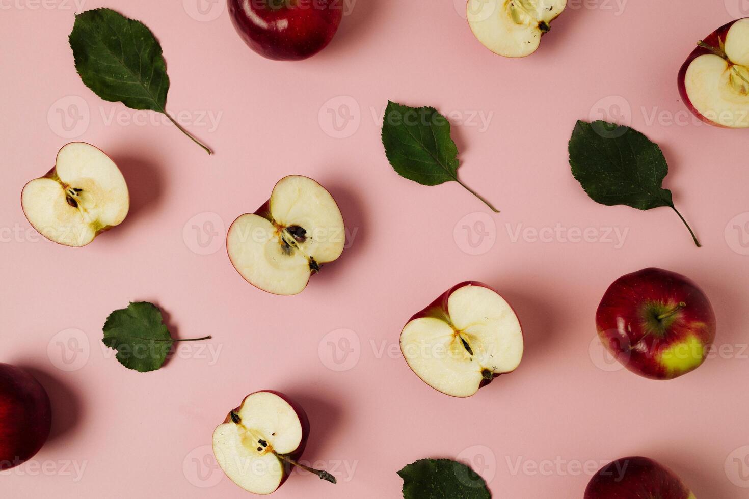 Red apple, half apple and quarter apple on pink background. Top view, healthy food concept. Top view. photo