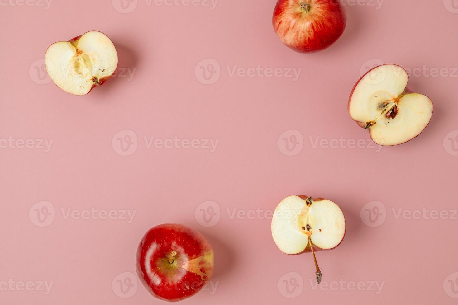 Red apple, half apple and quarter apple on pink background. Top view, healthy food concept. Top view. photo