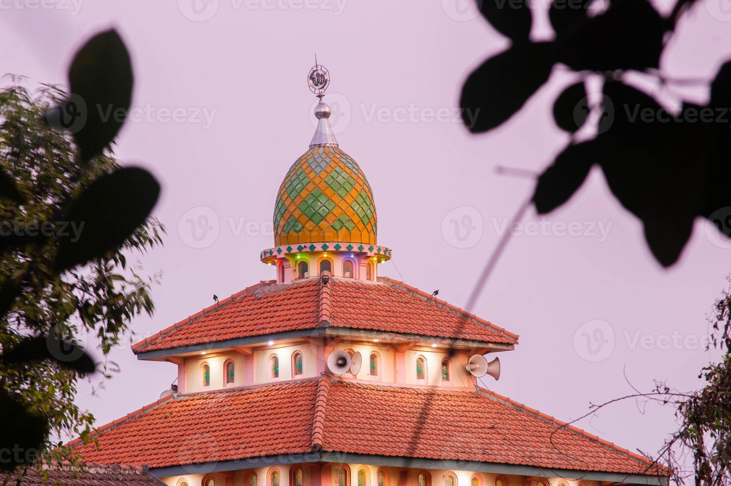 view of the mosque before sunset with the lights on photo