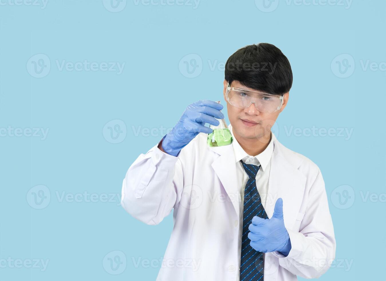 Man asian student education learning scientist wearing doctor gown in lab looking hand at chemist. caused by mixing reagents in scientific research laboratories with test tubes and microscope on table photo