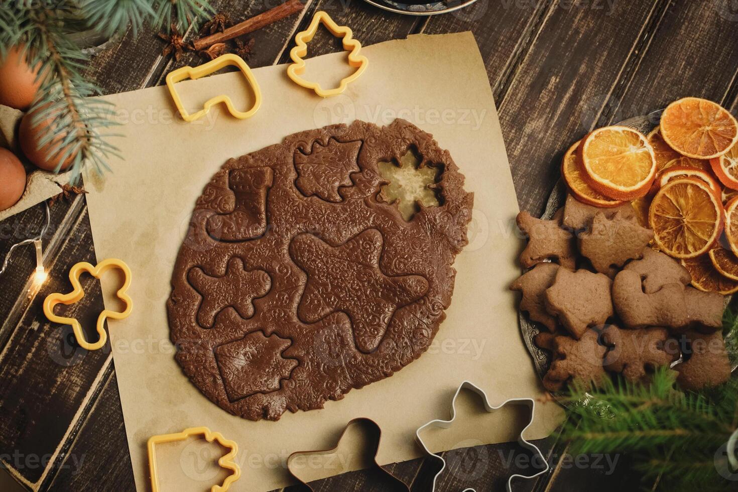 Rolled ginger dough and cookie cutters for making Christmas gingerbreads. photo