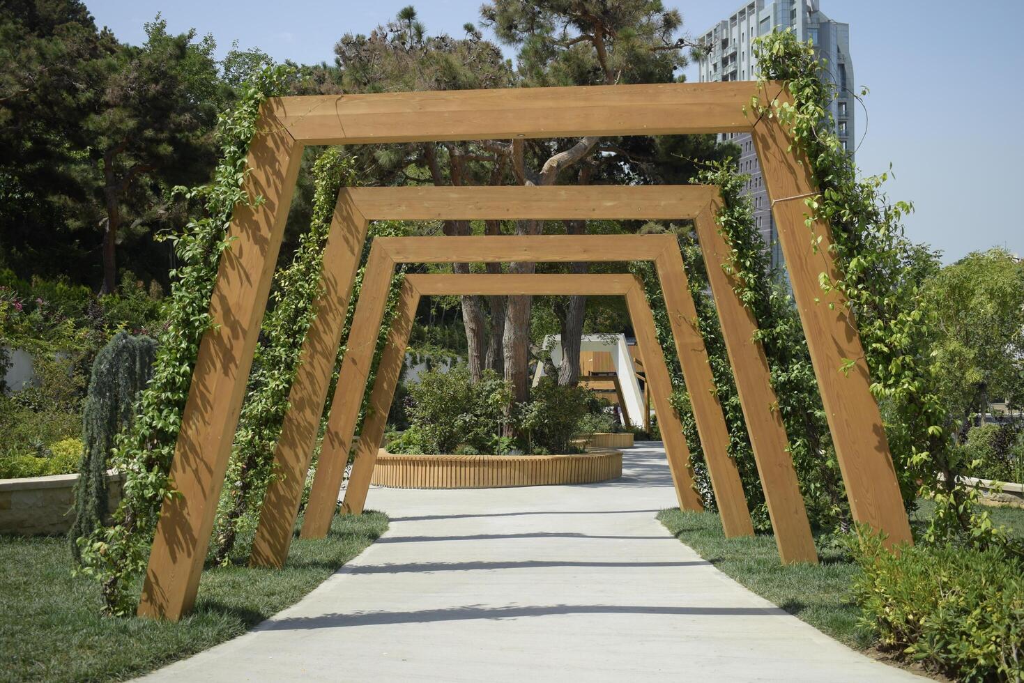 Decorative Wooden Archway with Greenery in a Park photo