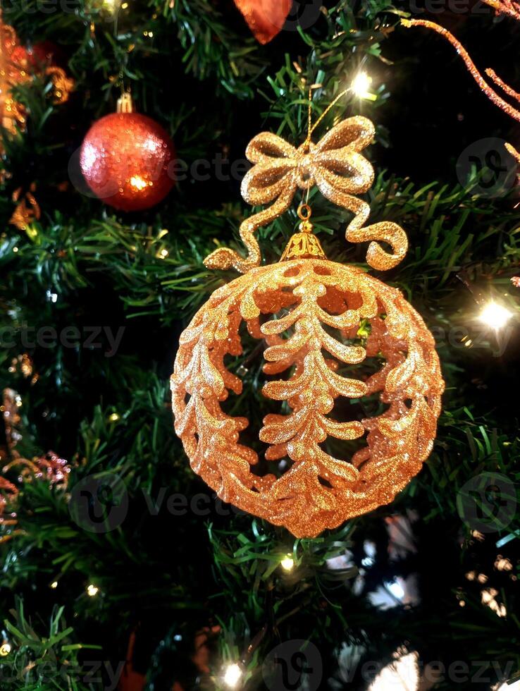 abstract twinkling christmas ornament decorated tree wallpaper background in gold sparkle glitter colored photo