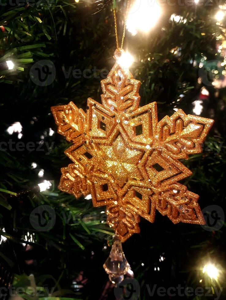 abstract twinkling christmas snowflakes ornament decorated tree wallpaper background in gold sparkle glitter colored photo