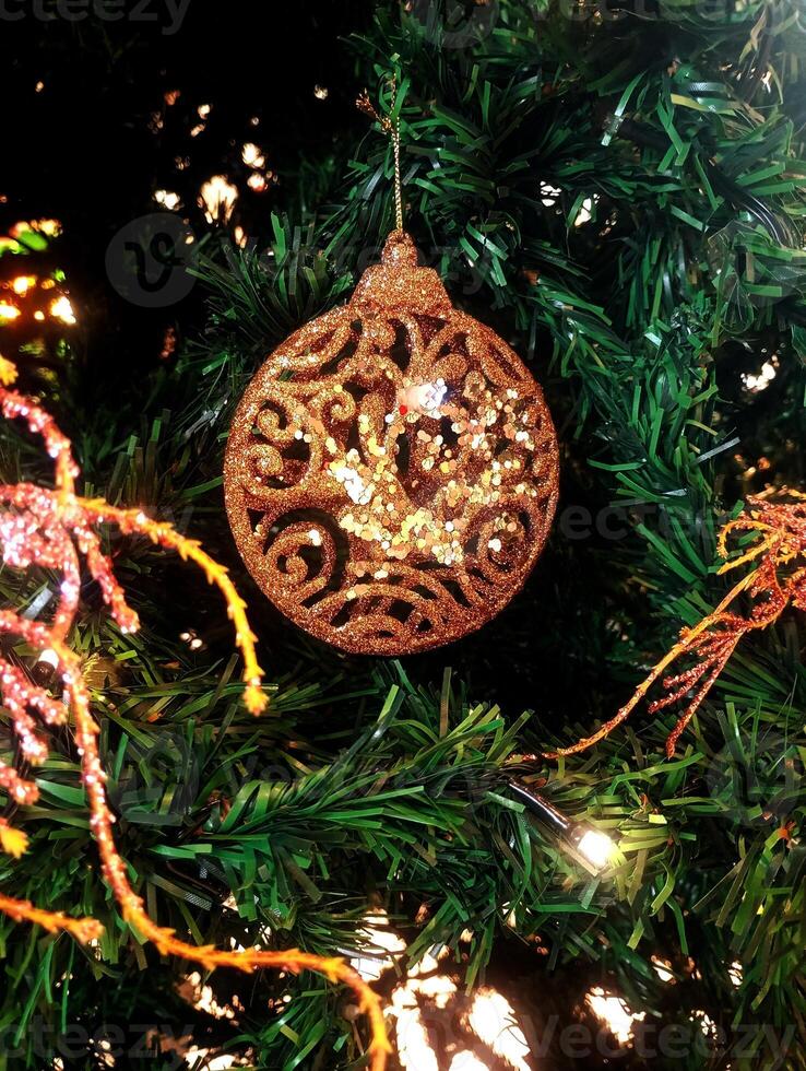 abstract twinkling christmas ornament decorated tree wallpaper background in gold sparkle glitter colored photo