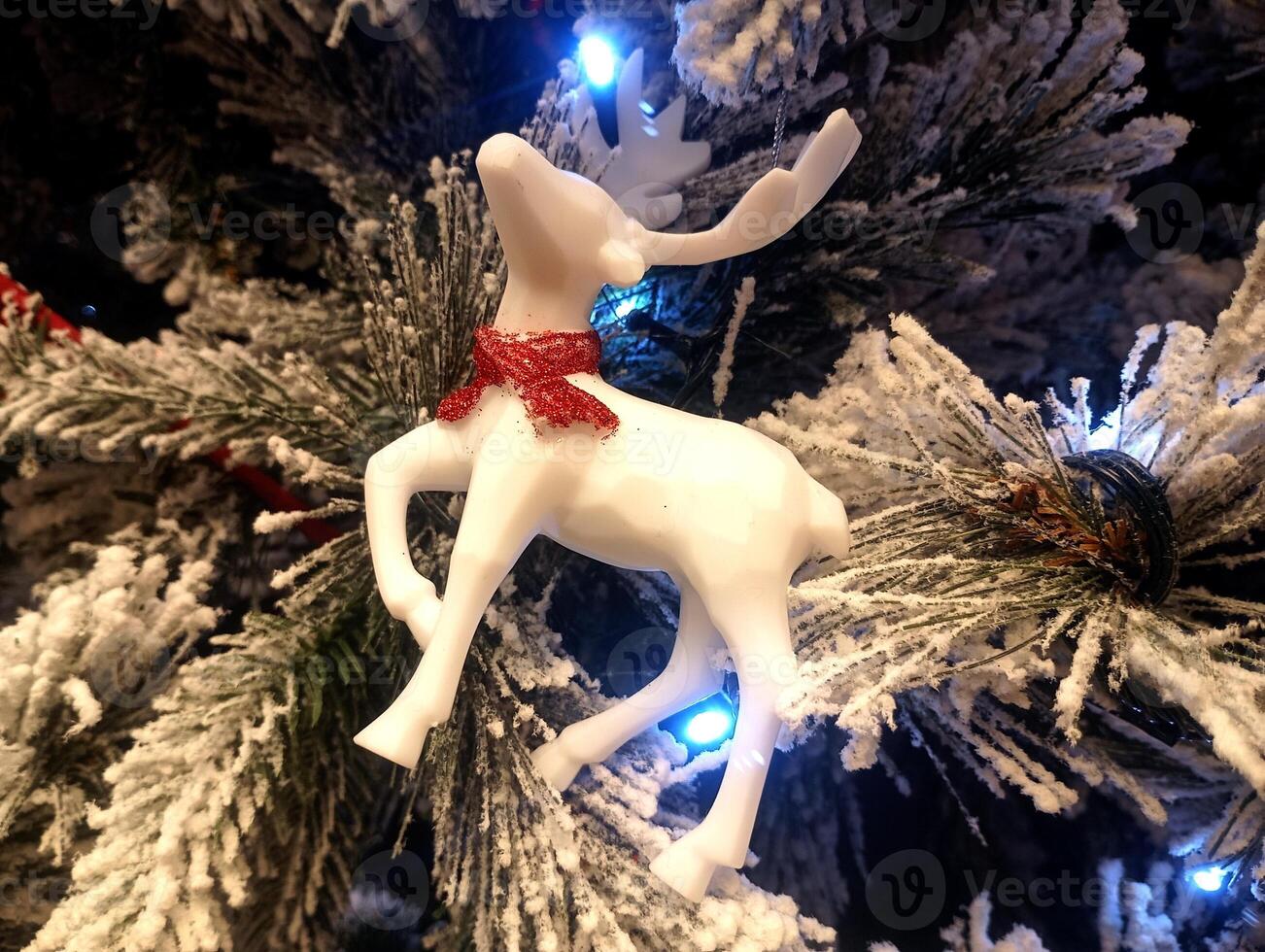 abstract christmas deer ornament decorated tree wallpaper background in white colored photo