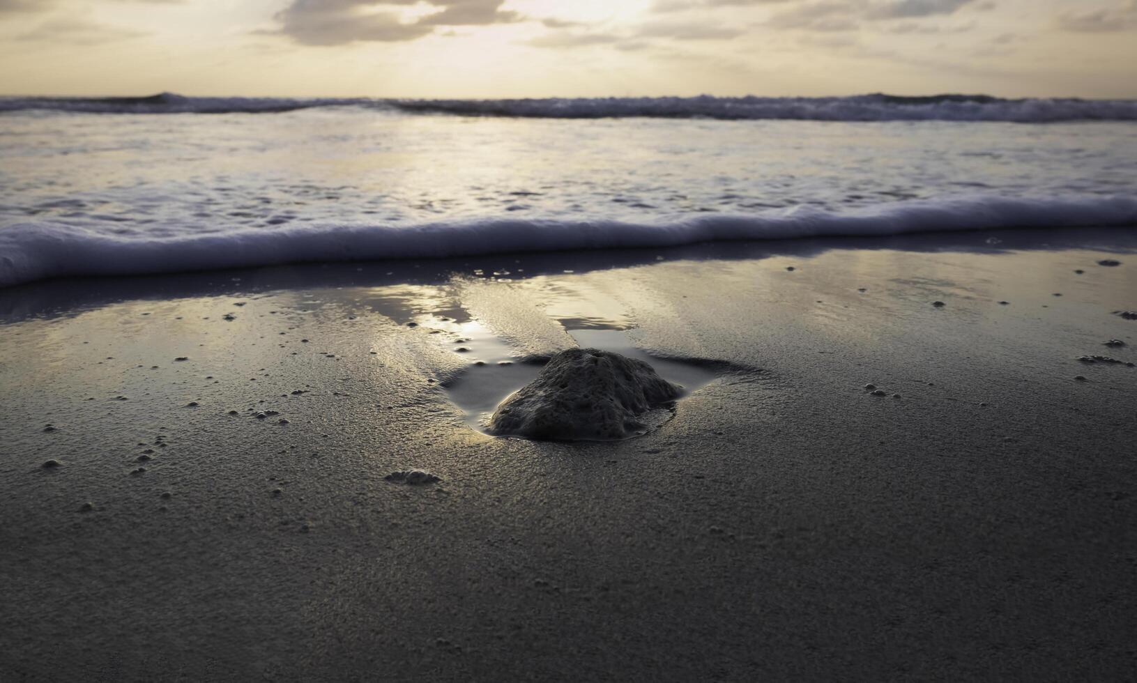 Wet sand ground floor and blurred sea wave on the beach,Silhouette style, photo