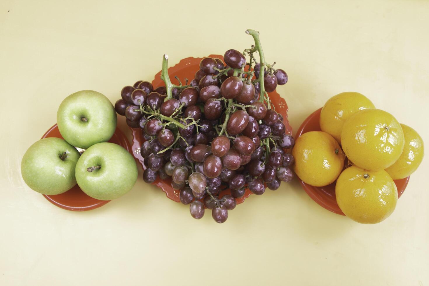 Grapes,Oranges and Apples put on background photo