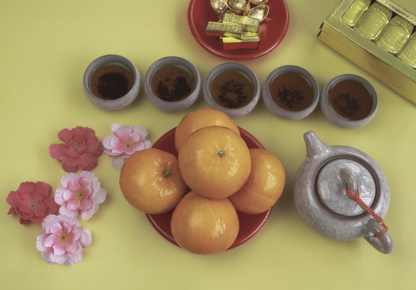 Orange put beside Chinese Tea on background photo