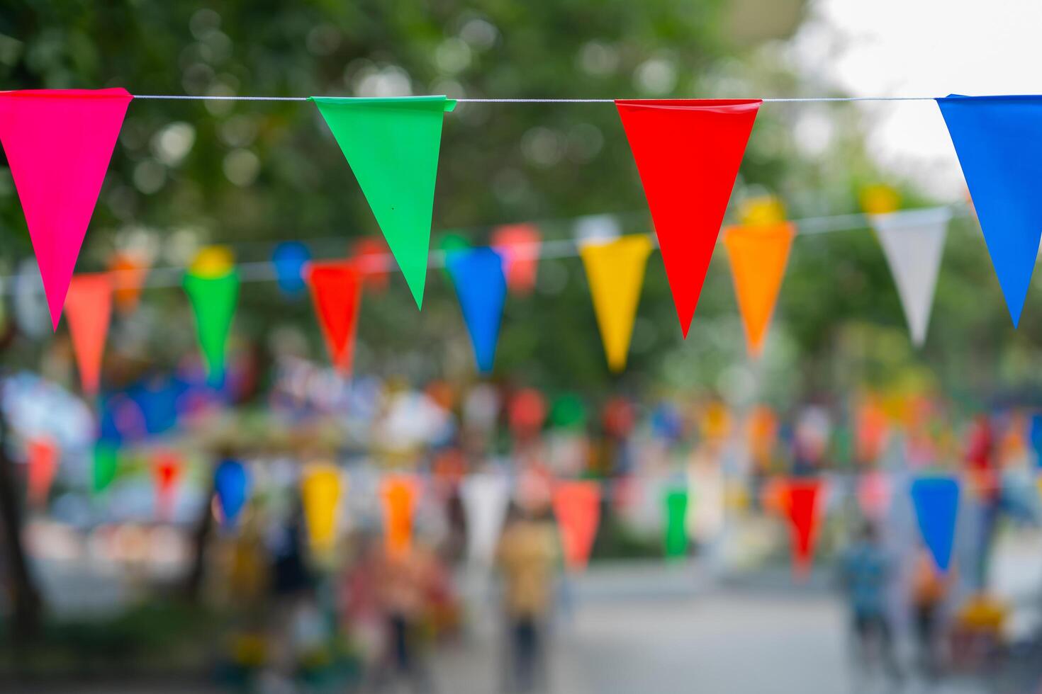 Decorative multi-colored triangle flags against the background at the festival in Thailand. photo
