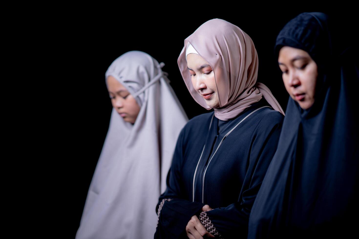 Many groups of Asian Muslim women in the Islamic religion in hijabs of cream and black color. She was praying in a beautiful mosque out of respect for God. photo