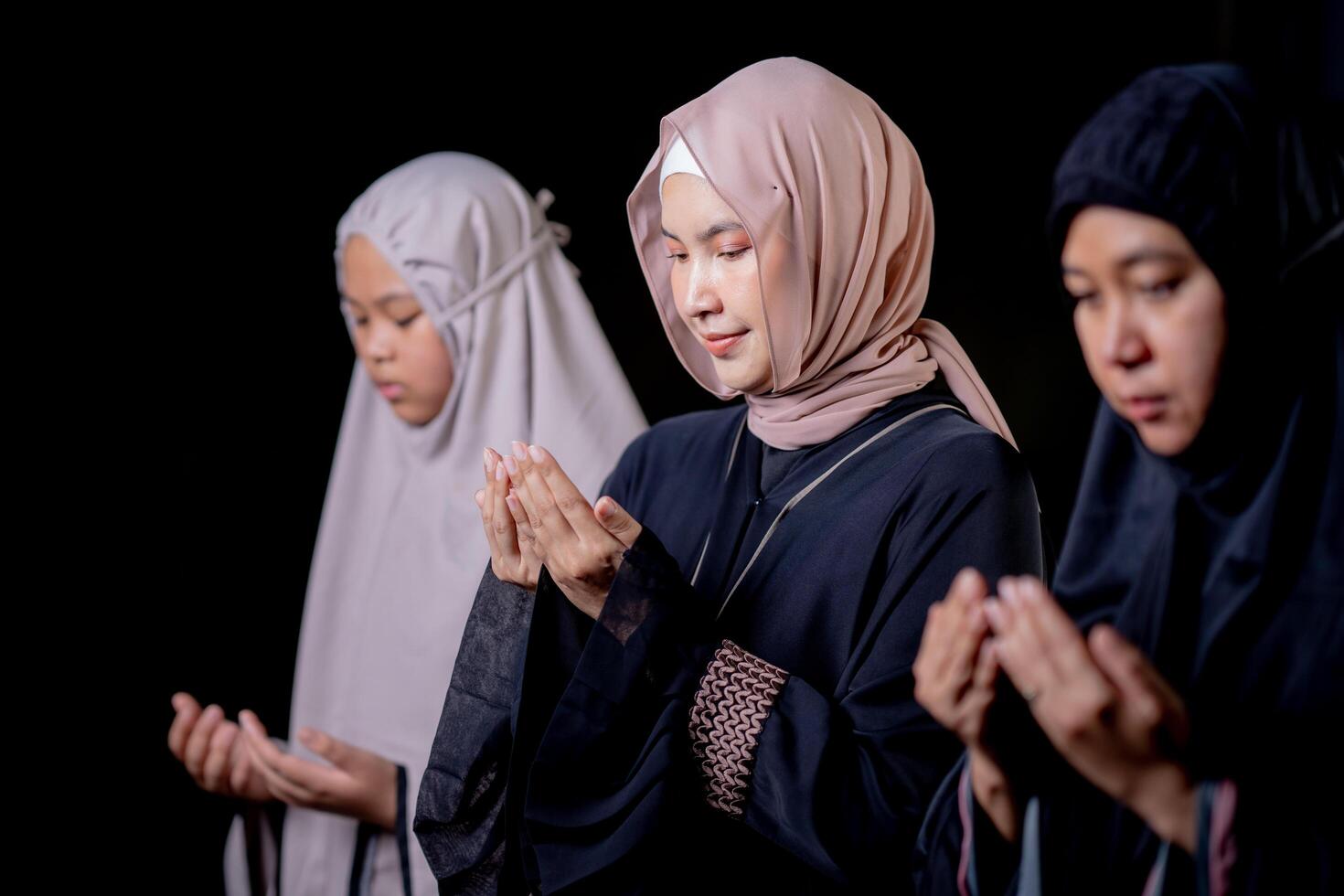 Many groups of Asian Muslim women in the Islamic religion in hijabs of cream and black color. She was praying in a beautiful mosque out of respect for God. photo