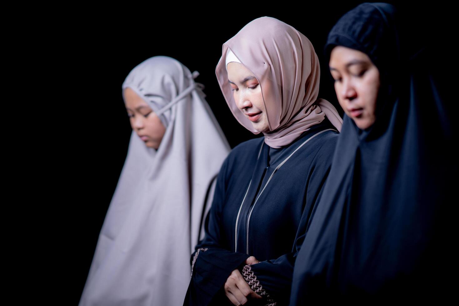 Many groups of Asian Muslim women in the Islamic religion in hijabs of cream and black color. She was praying in a beautiful mosque out of respect for God. photo