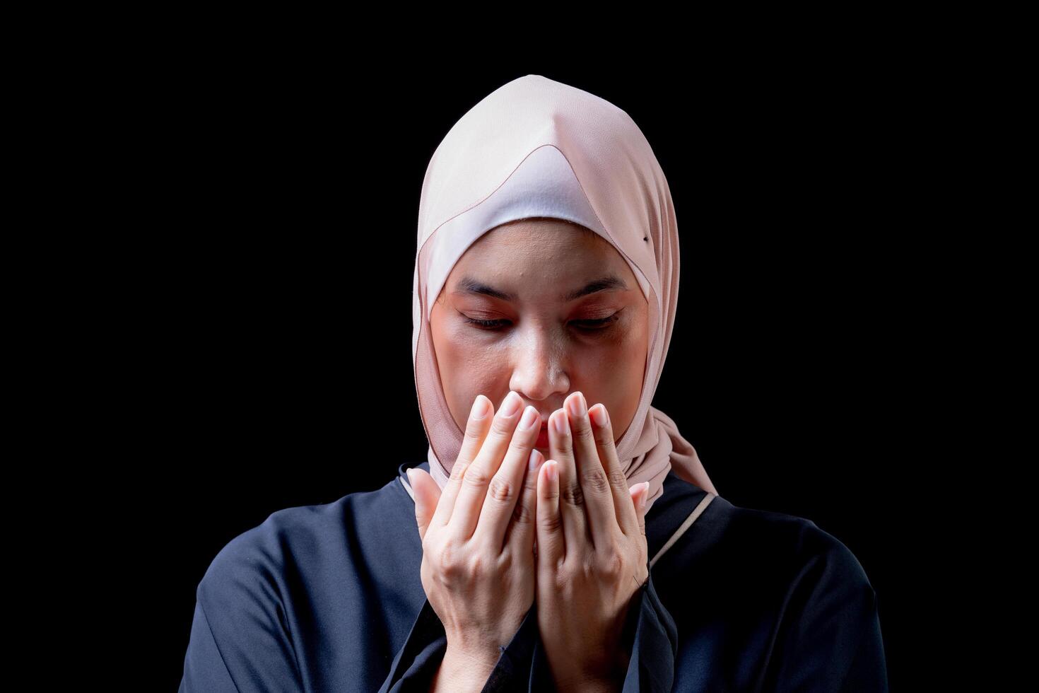 The image of an Asian Muslim woman in the Islamic religion in hijab in cream color. She was praying in a beautiful mosque out of respect for God. photo