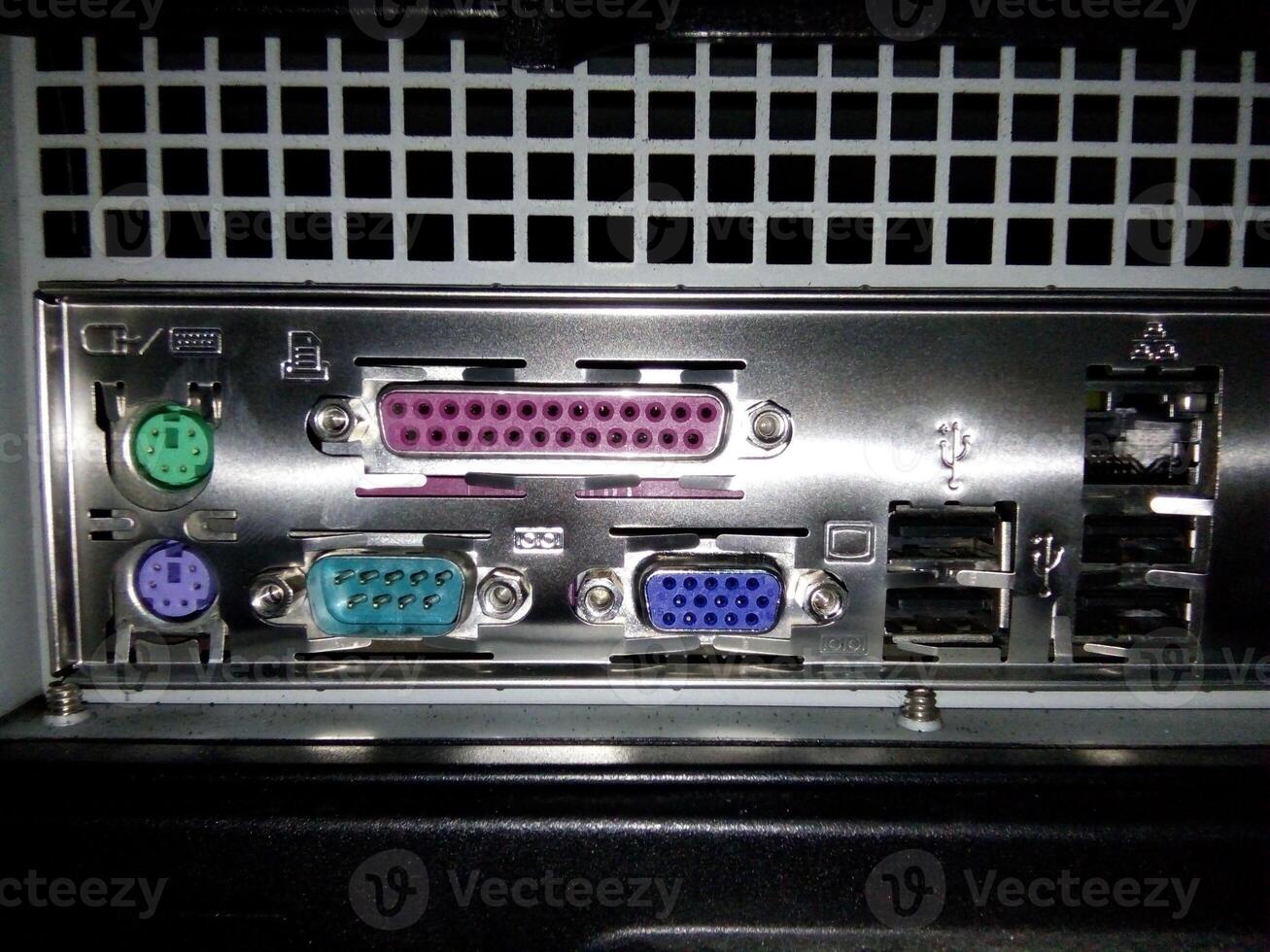 The back of a computer with several different types of connectors photo