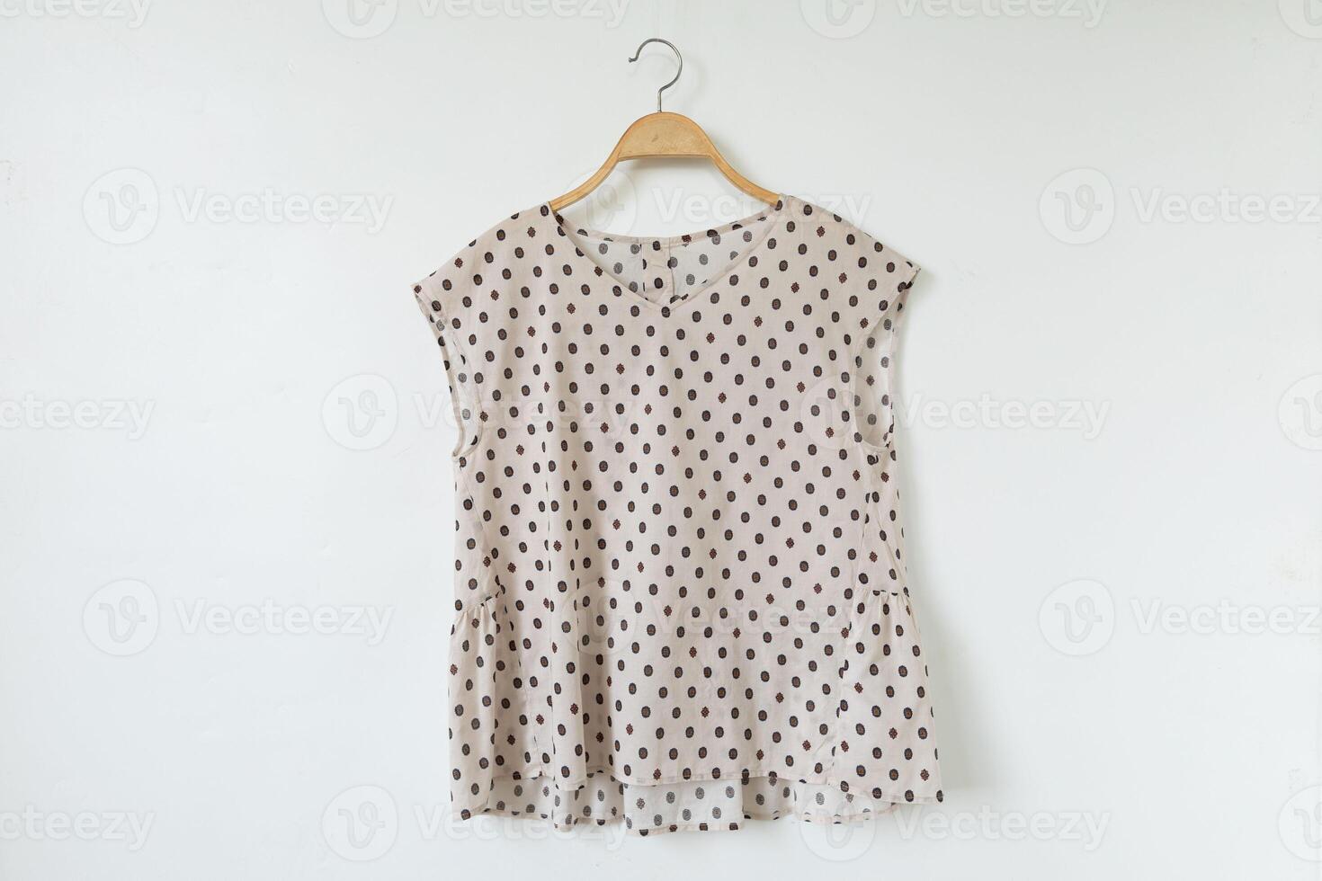 Woman clothes on a hanger with a polka dot pattern. photo