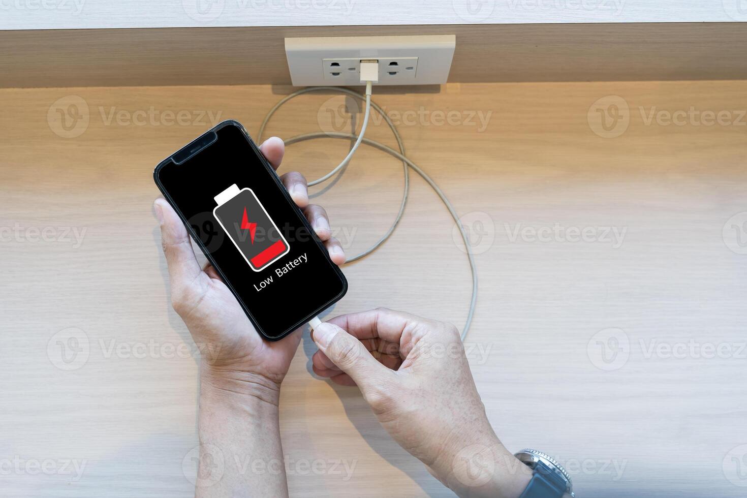 Close up man's hands using smart phone battery low charge battery screen, Businessman holding a smartphone Low battery photo
