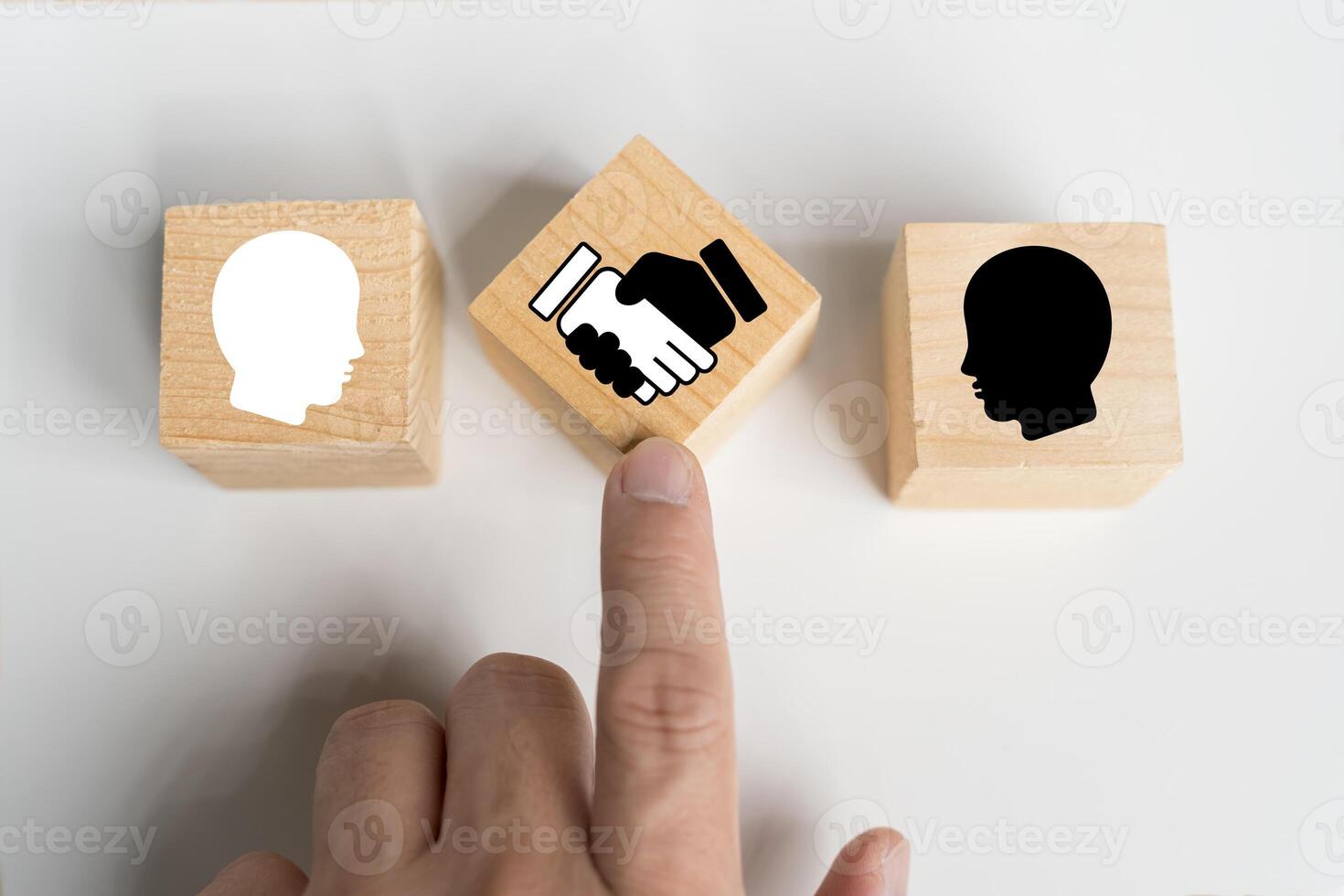 Negotiation concept. Wooden block with handshake icon and businessman icon for negotiation photo