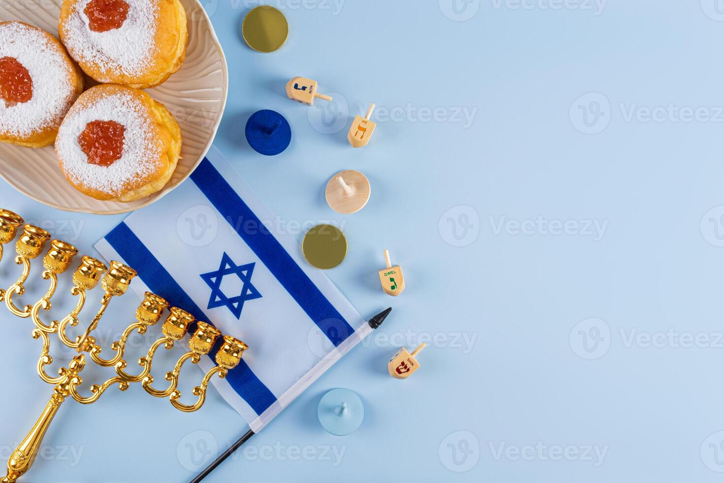 Traditional treats and symbols for the Jewish holiday of Hanukkah. Upper view. Blue background. A copy of the space. photo
