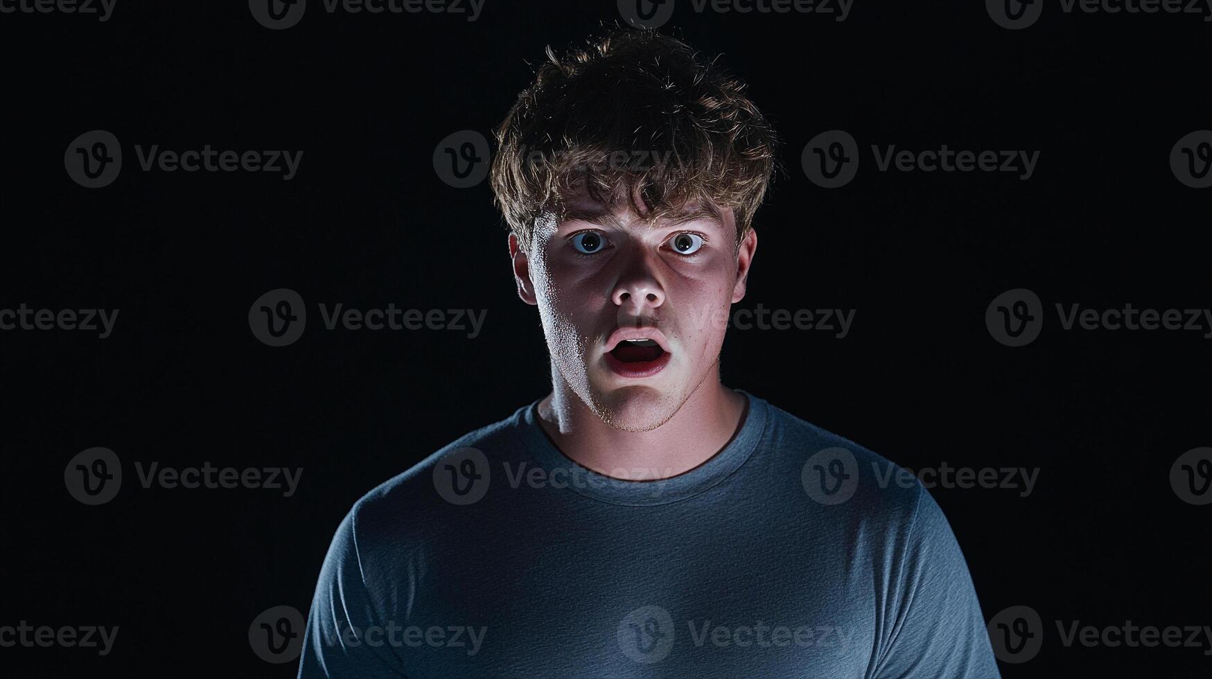 A man with an open mouth and a shocked expression photo