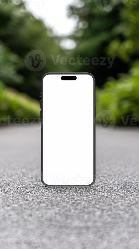 Black smartphone mockup template with blank screen on the road photo