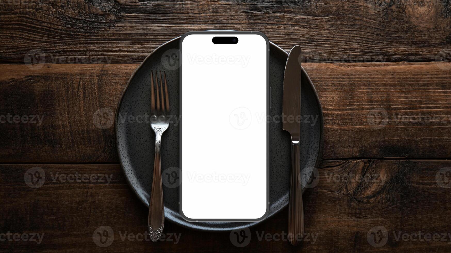 Black smartphone mockup template with blank screen on plate with knife and fork photo