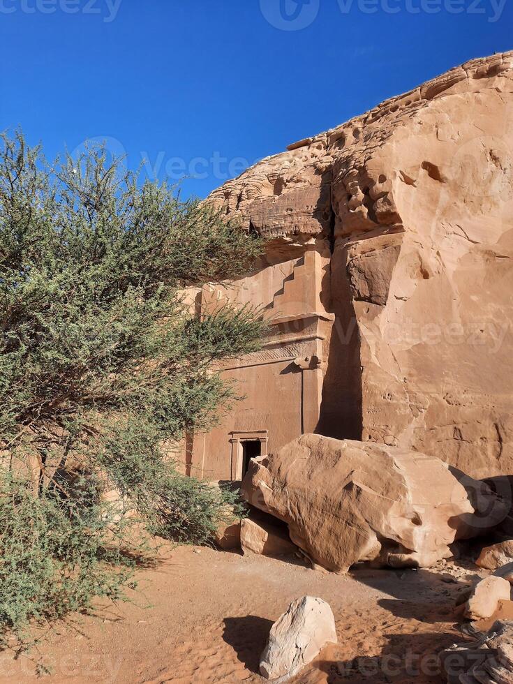 A beautiful view of the caves built into the mountains at the archaeological site of Hegra in Madain Saleh, AlUla in Saudi Arabia. photo