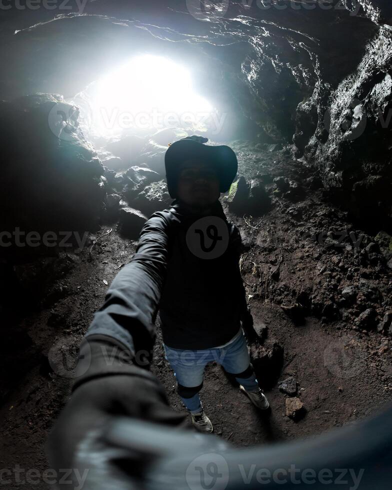 Exploring a volcanic cave with ambient light during a thrilling adventure photo