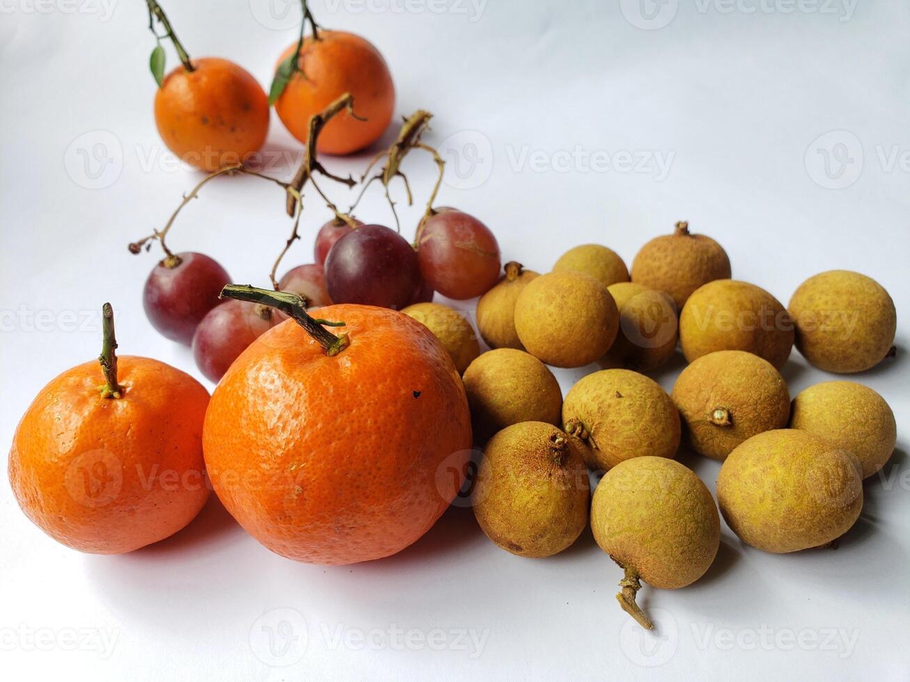 A group of oranges and grapes on a table photo