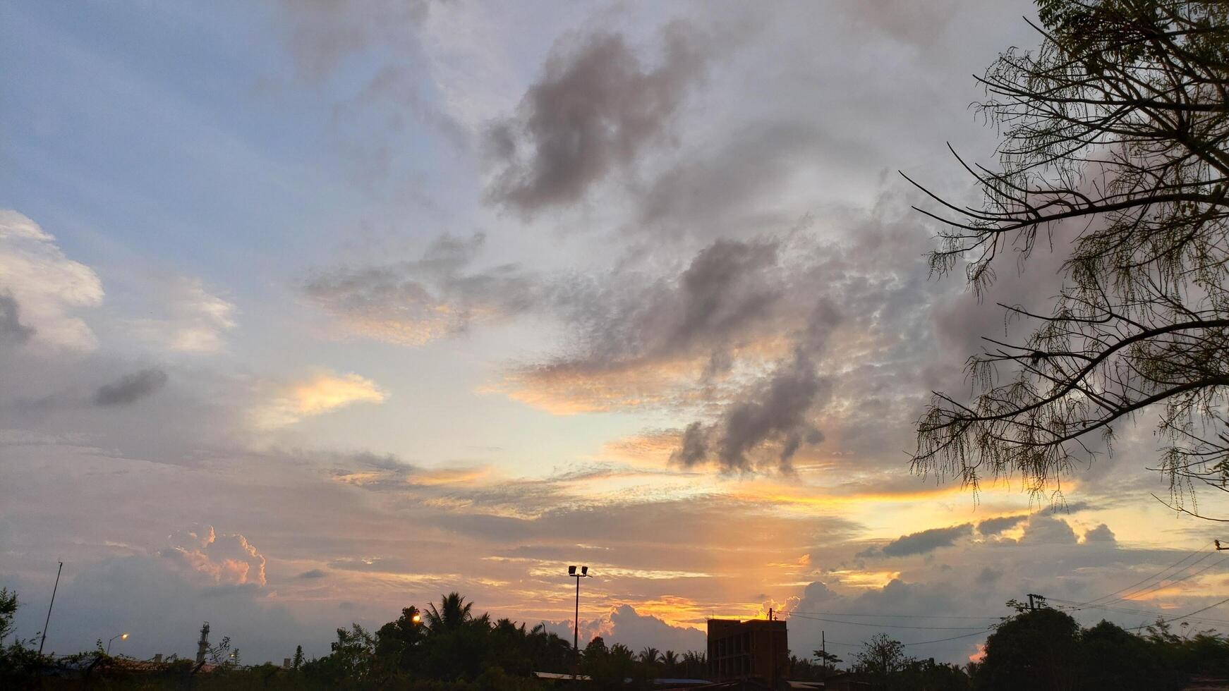 Dramatic Sunset with Clouds and Trees Silhouettes photo