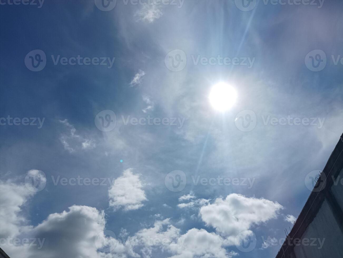 Bright Sun in a Blue Sky with Clouds photo