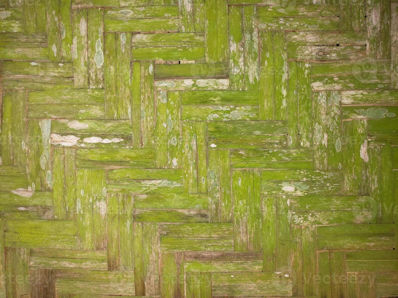 A green wall with a pattern of wood photo