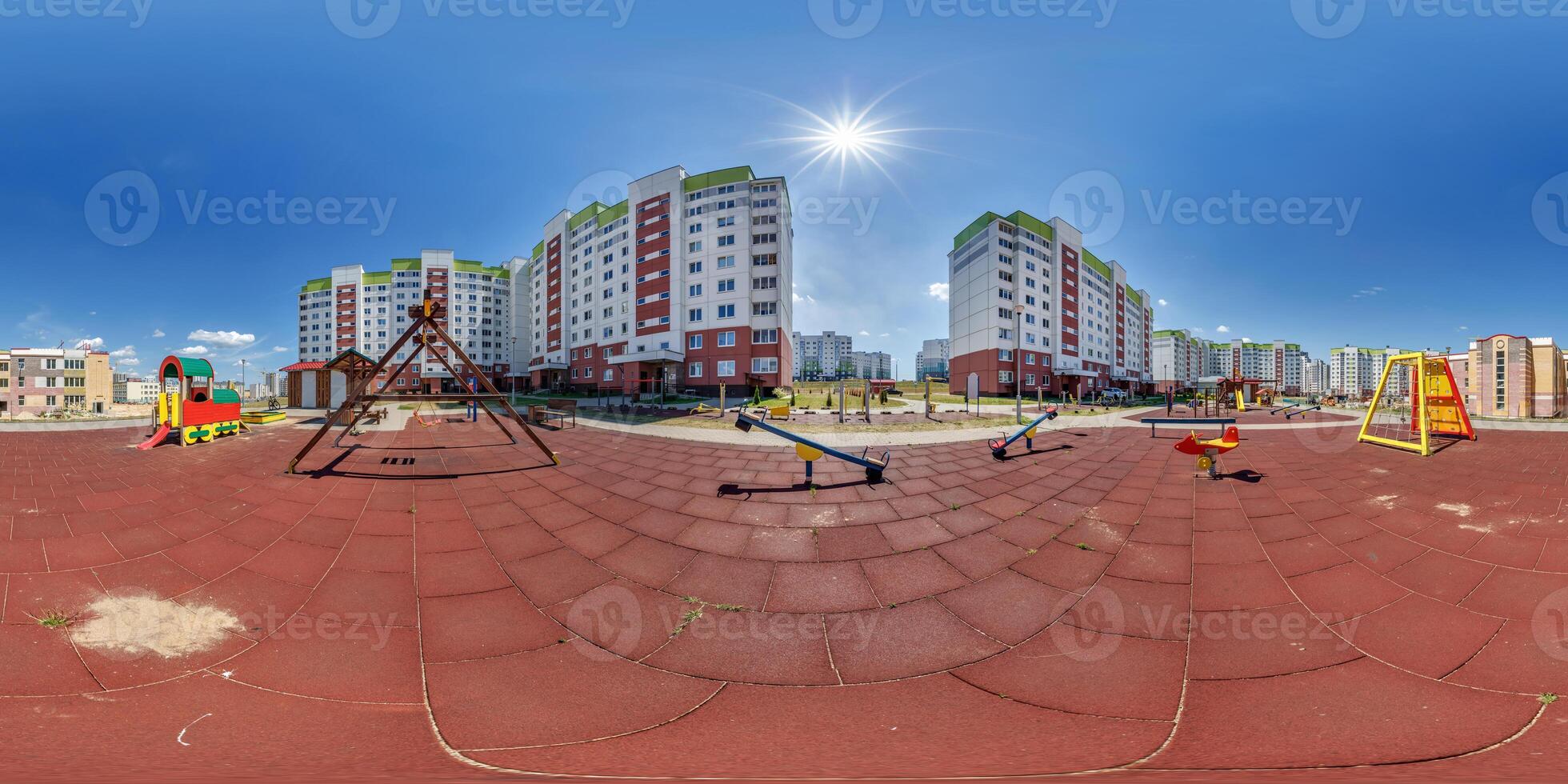 360 hdri panorama on sports or childrens playground in middle of residential complex among skyscrapers buildings with outdoor exercise equipment gym in equirectangular projection. landscaping concept photo