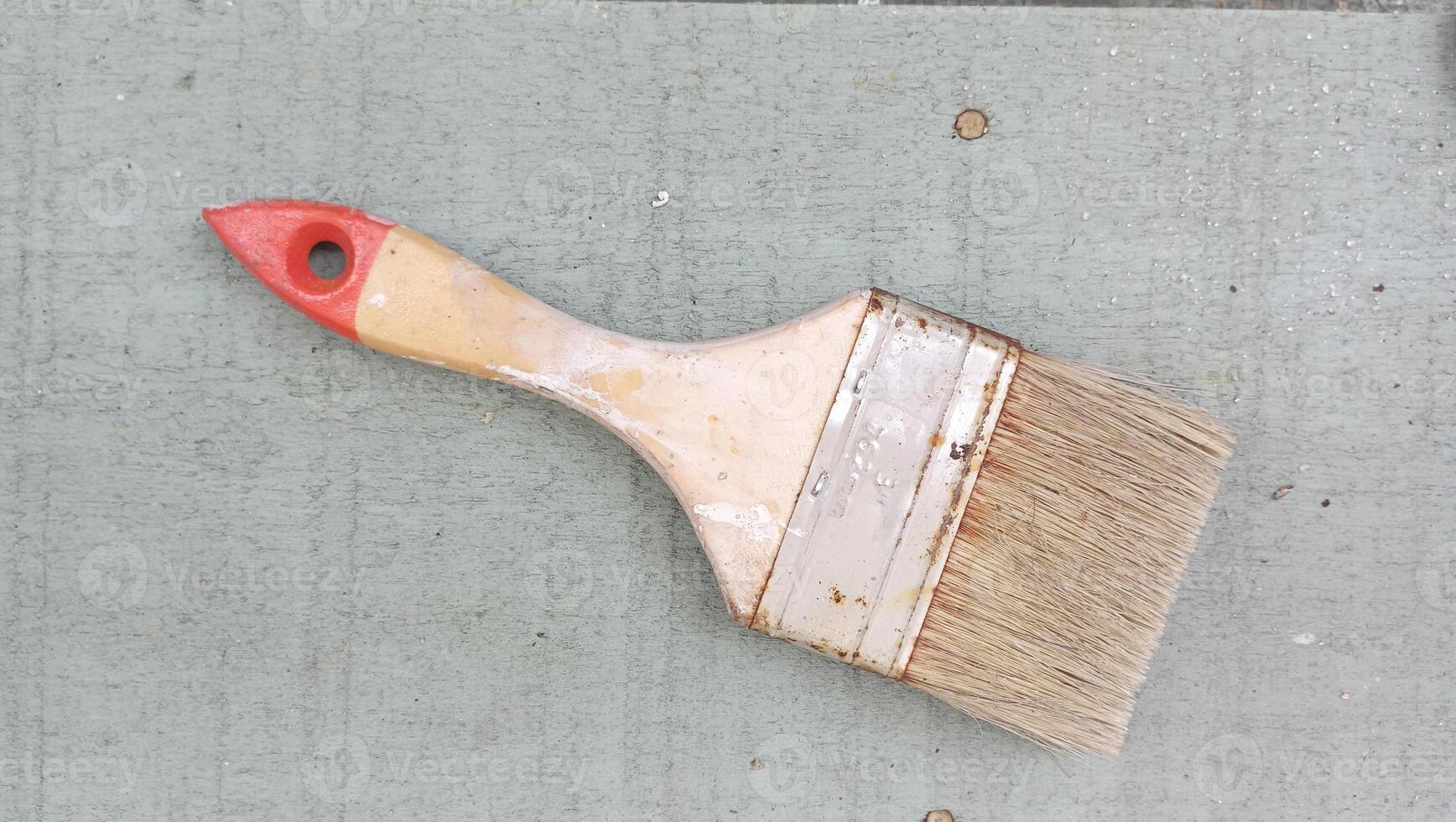 Rustic Paintbrush on Weathered Wooden Surface photo