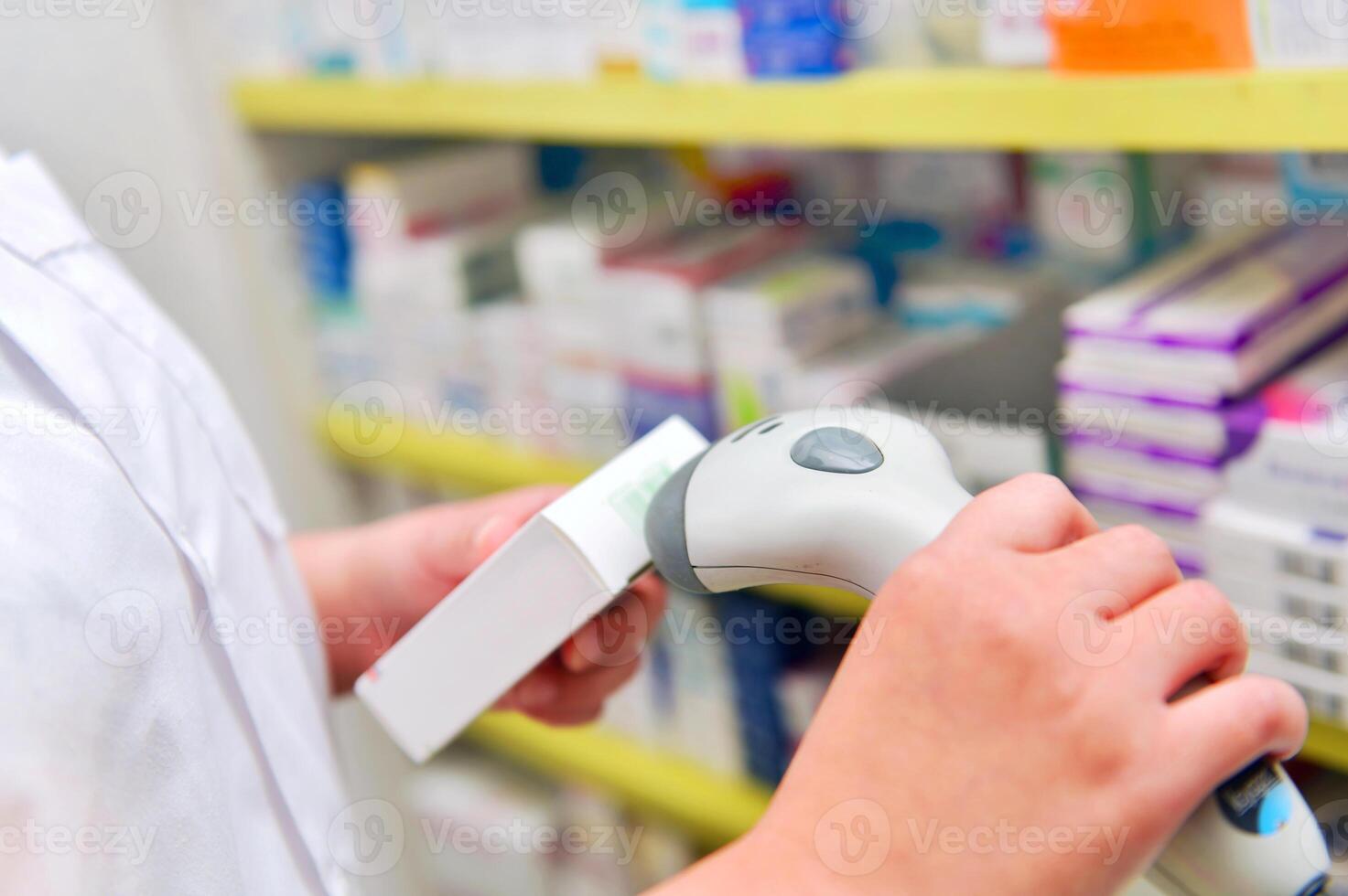 Pharmacist scanning barcode of medicine drug in a pharmacy drugstore photo