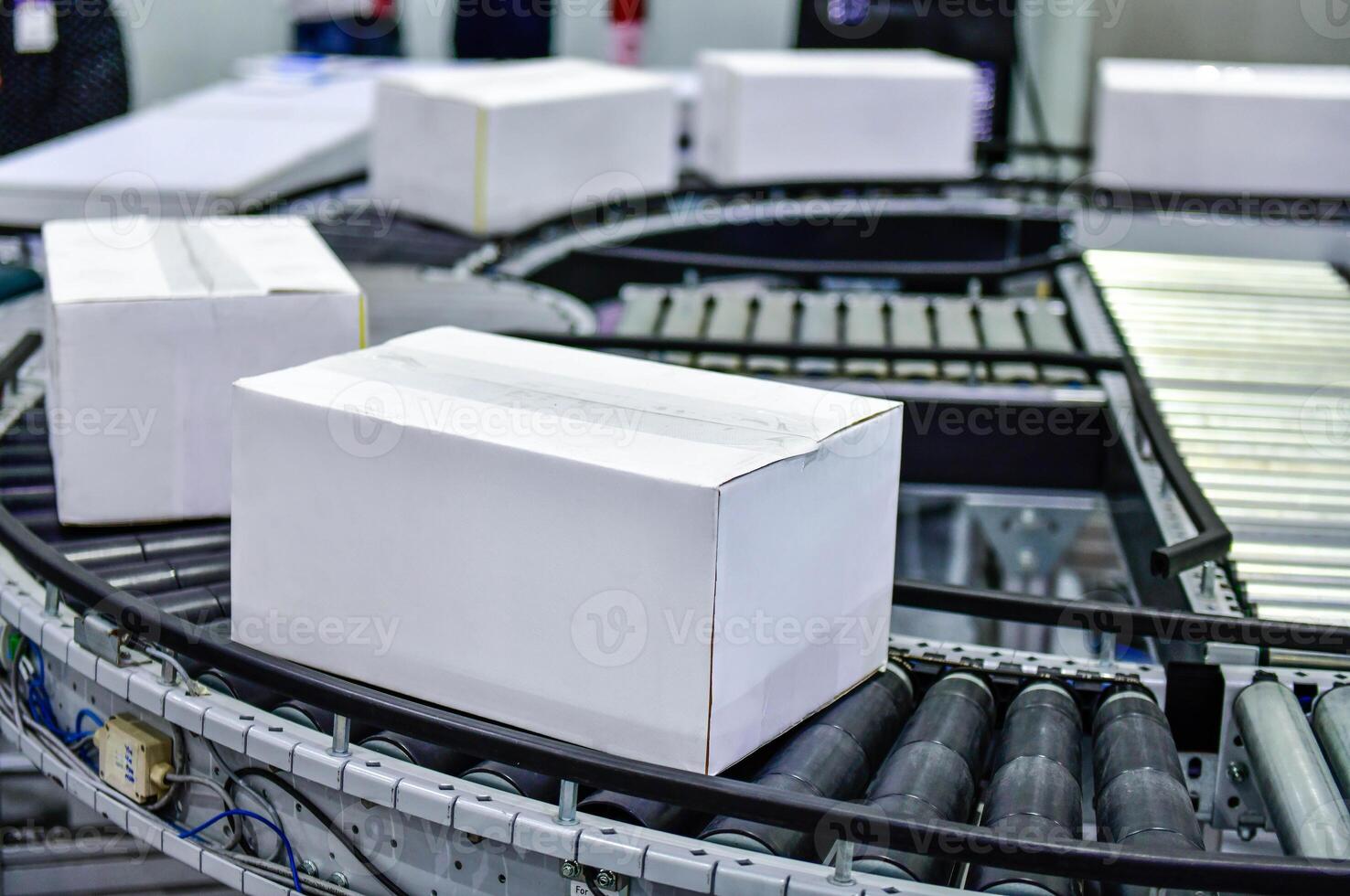 White cardboard boxes on conveyor belt. parcels transportation system concept photo