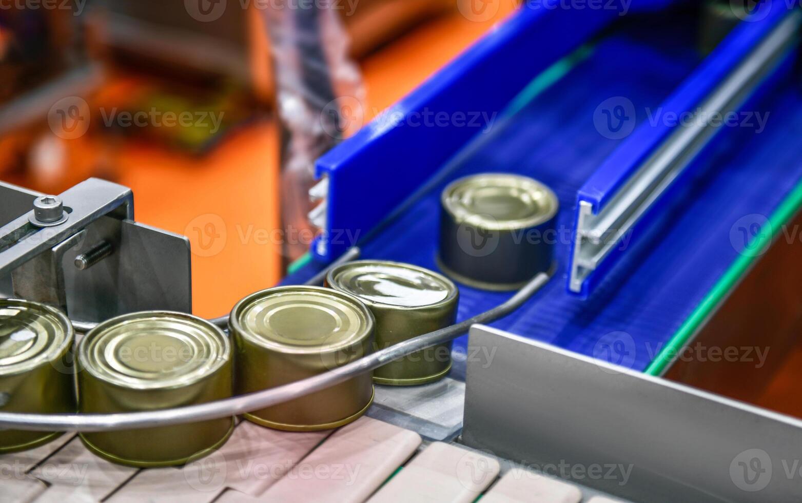 Canned food products on conveyor belt in distribution warehouse.parcels transportation system concept. photo