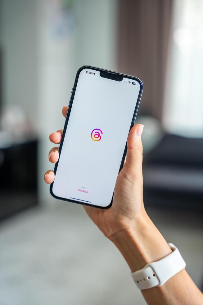 Prague, Czech republic - May 2, 2024. Woman holding iPhone with logo of application Instagram on the screen, using mobile application for business home. High quality photo