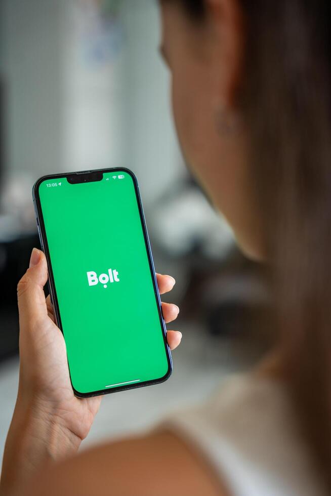 Prague, Czech republic - May 2, 2024. Woman holding iPhone with logo of application Bolt on the screen, using mobile application . High quality photo