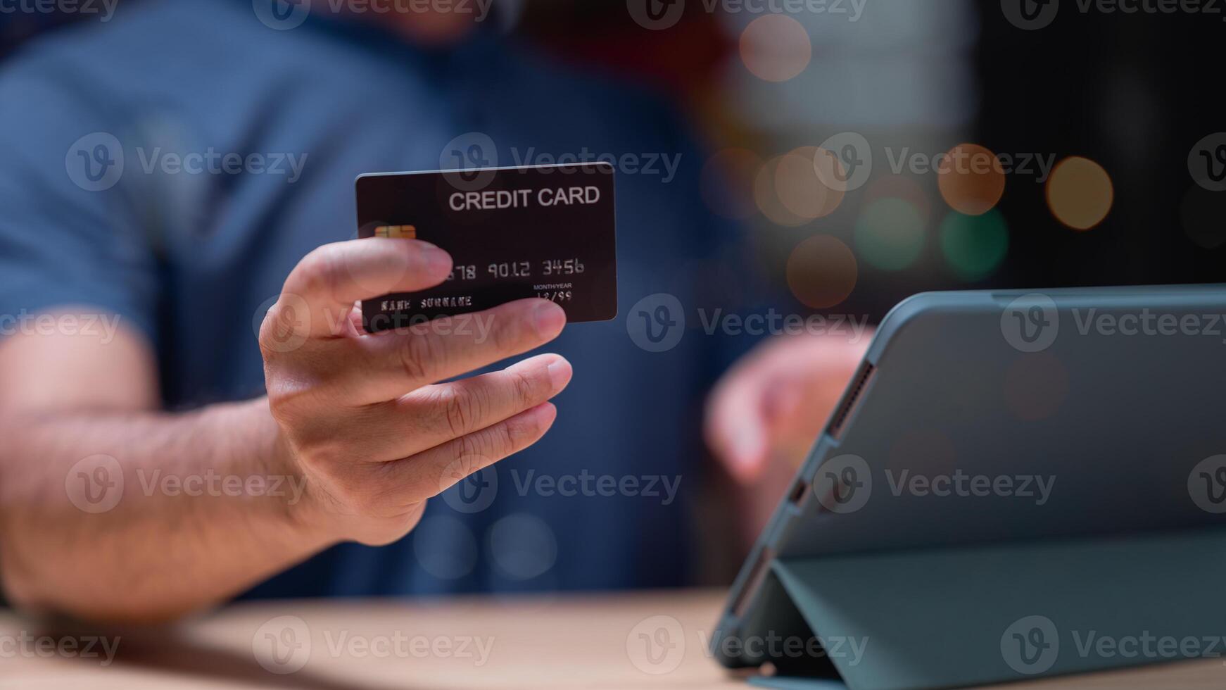 People shopping online using tablet concept. Person holds credit card while engaging in online shopping on tablet scene convenience of digital transactions in todays modern world photo