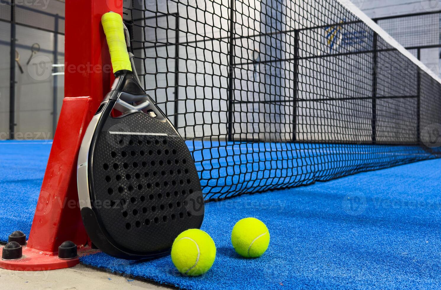 padel racket on a padel blue court with a ball photo