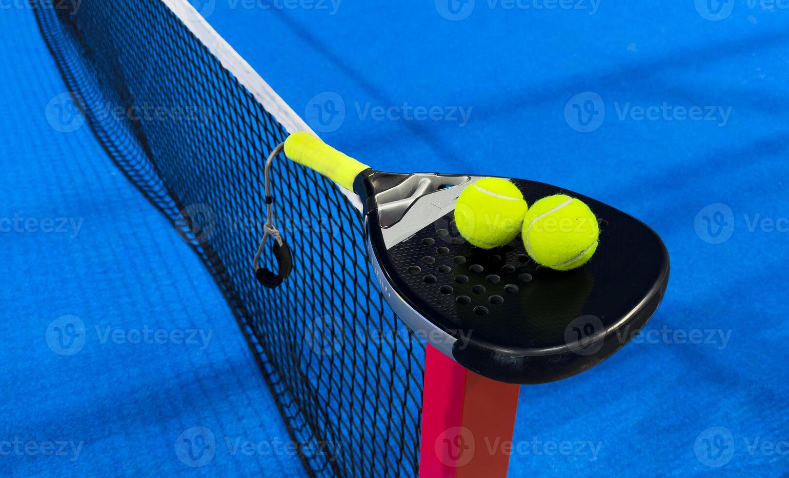 padel racket on a padel court with a ball photo
