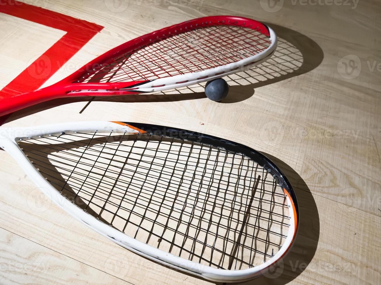 Empty squash court and rackets on the wooden floor. photo