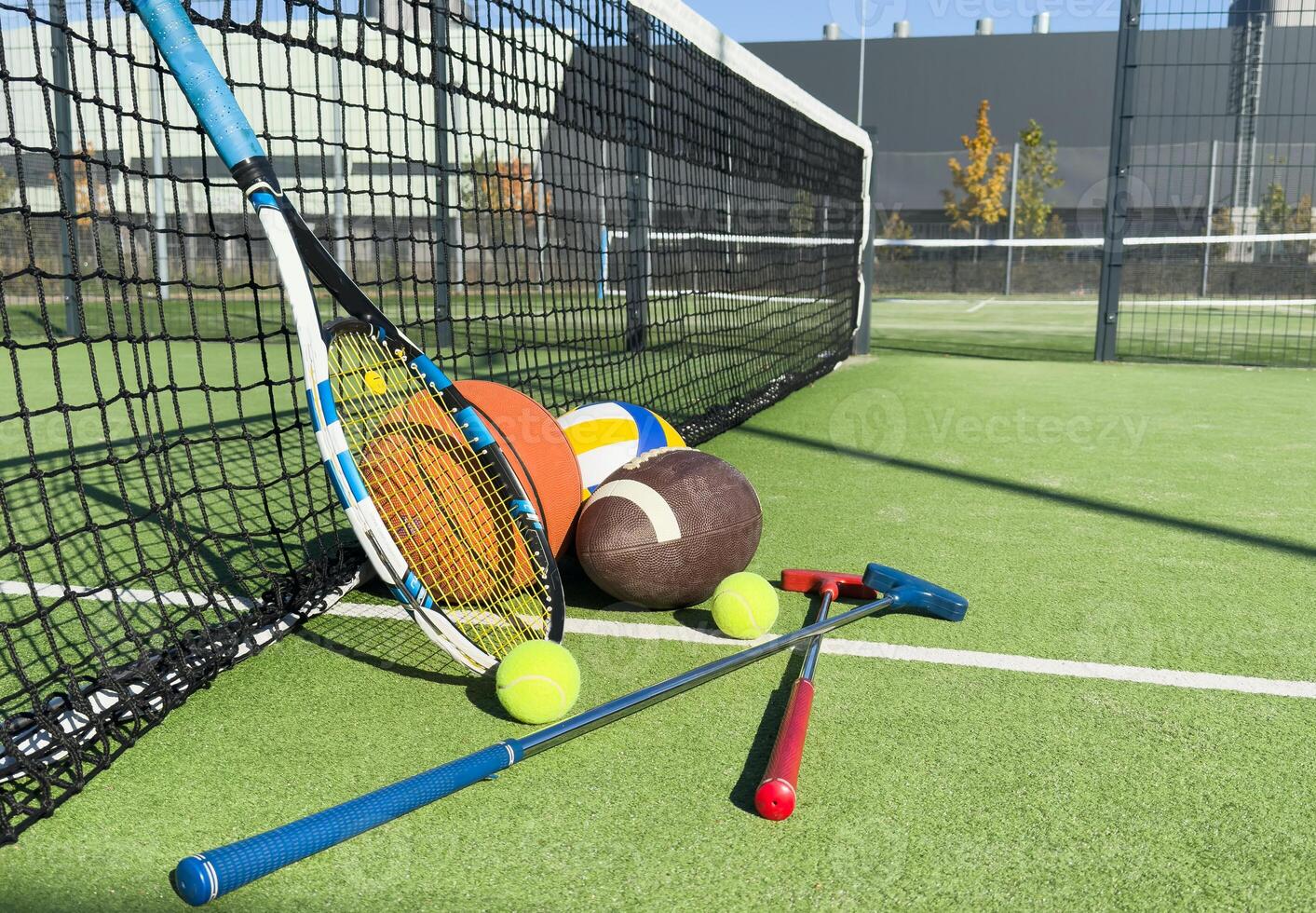 Different sport equipment on green grass, flat lay. Space for text photo