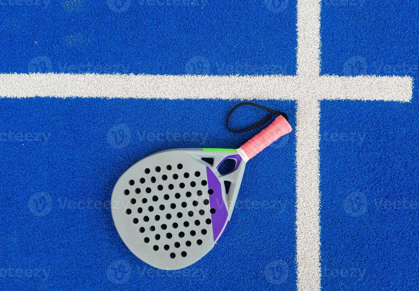 professional paddle tennis racket with natural lighting on blue background. Horizontal sport theme poster, greeting cards, headers, website and app photo