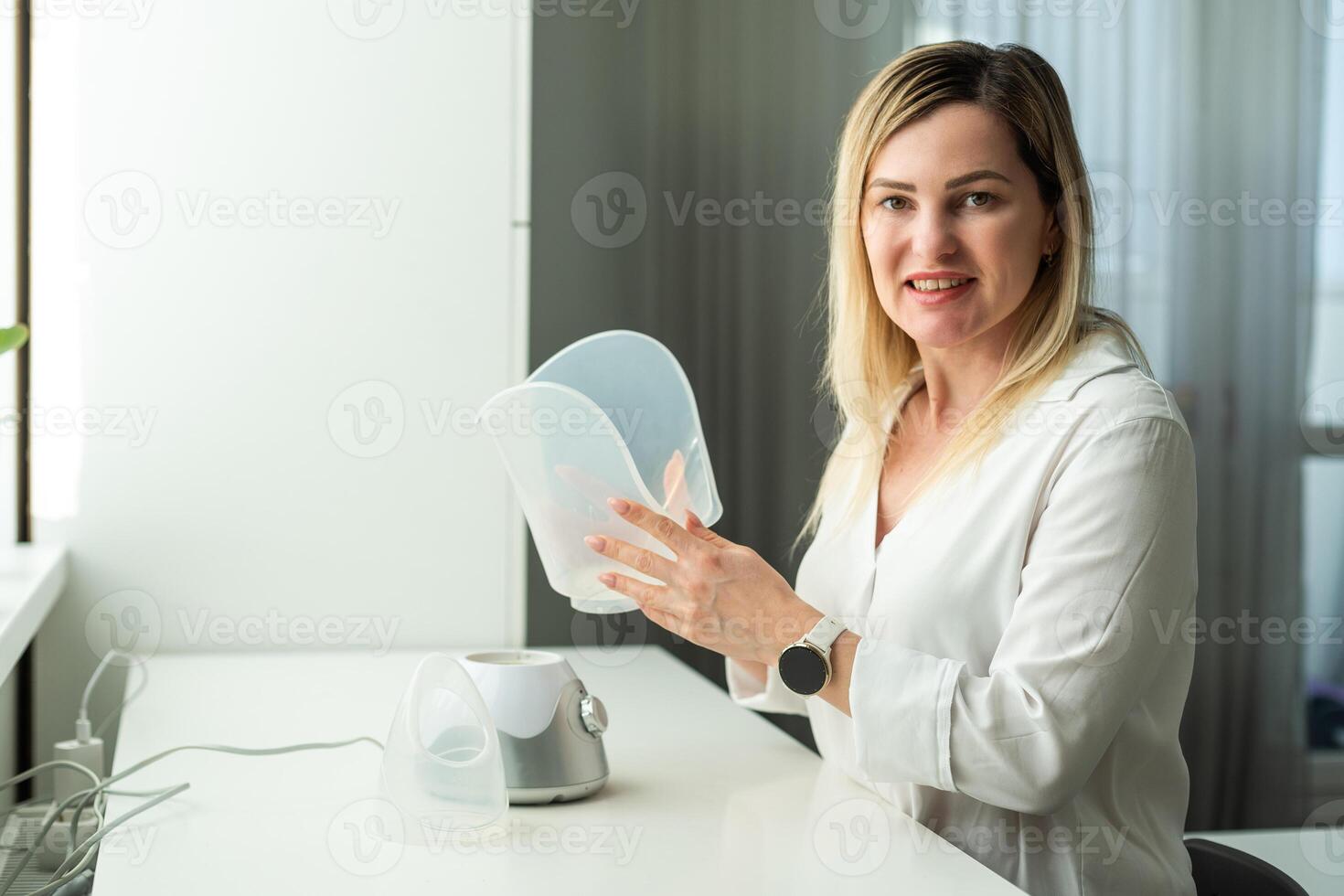 Young woman doing inhalation with a medical vaporizer nebulizer machine on black background photo