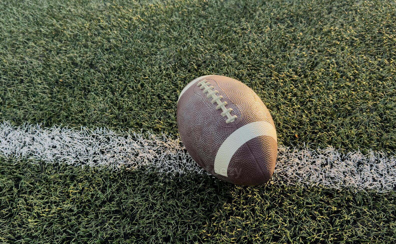 Football at the goal line on a grass field overhead view photo